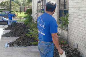 image of workers digging around slab foundation