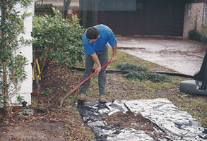 image of workers digging around slab foundation